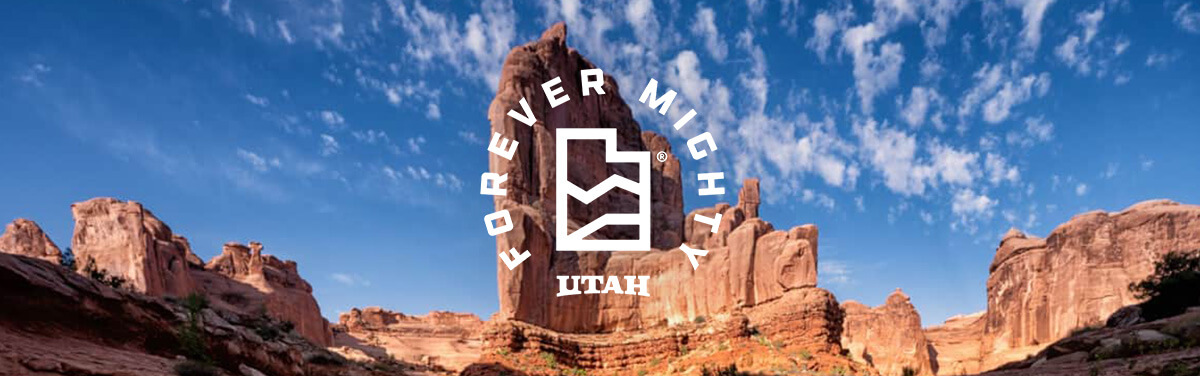 a desert rock formation with an overlay that says forever mighty