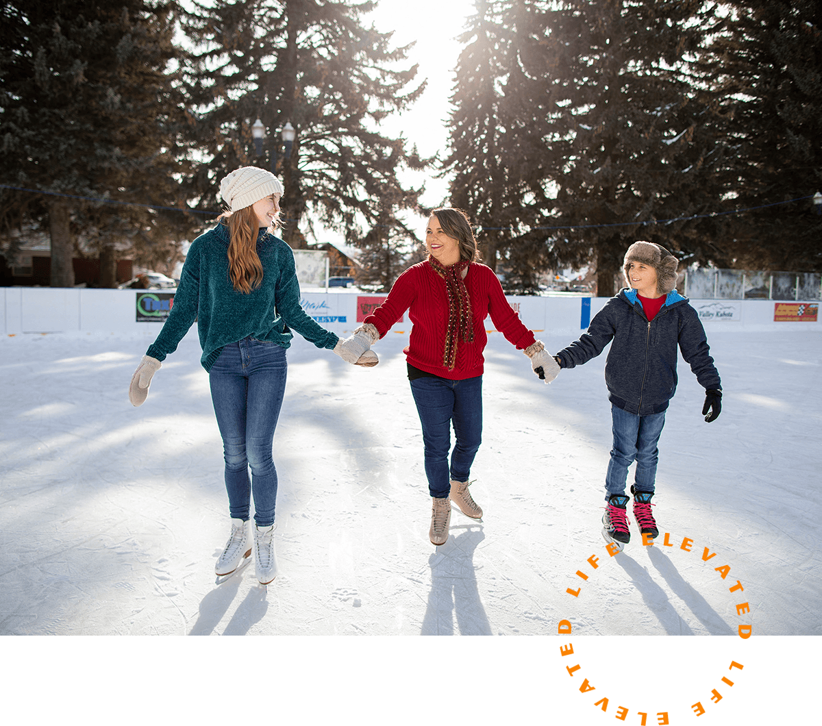 a family of three ice skating on a rink
