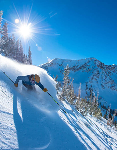a person skiing down a snow covered slope