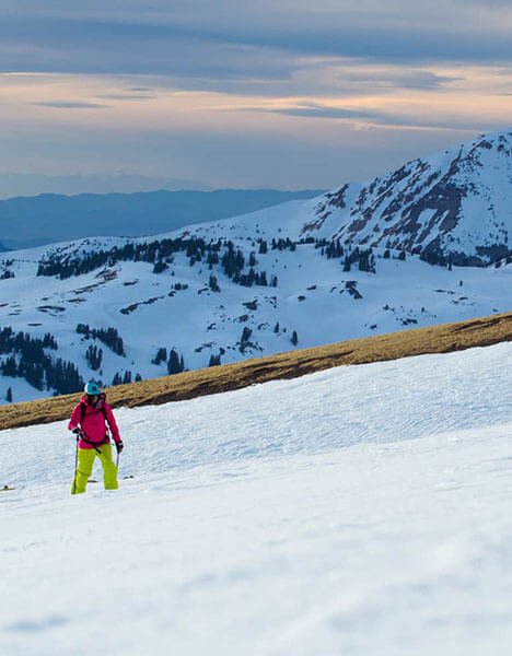 a person snowshoeing on a mountain in the snow