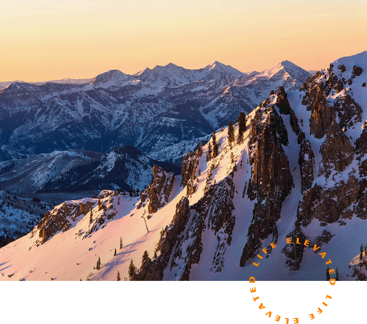the view of the mountains from the top of a mountain at sunset