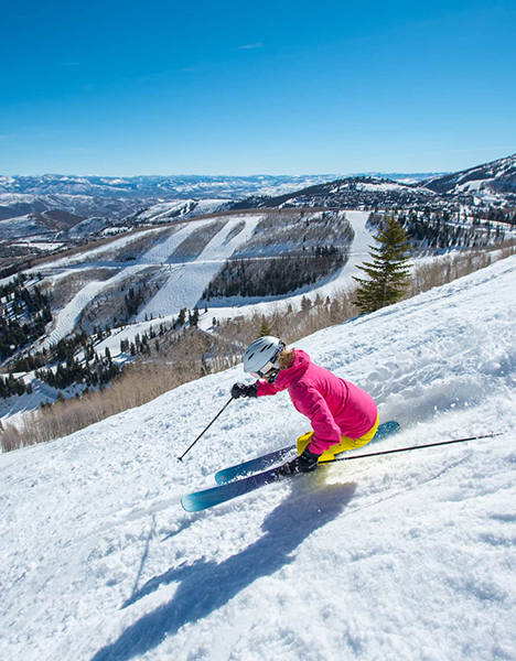 a person is skiing down a snow covered slope