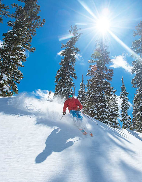 a person skiing down a snow covered slope