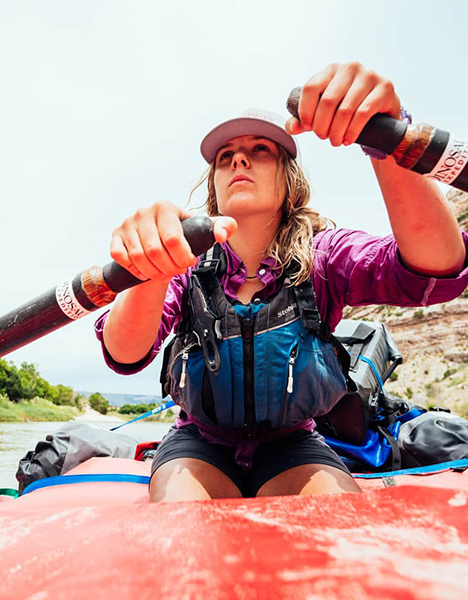 A woman steering a raft.