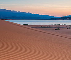 A sandy beach at sunset.