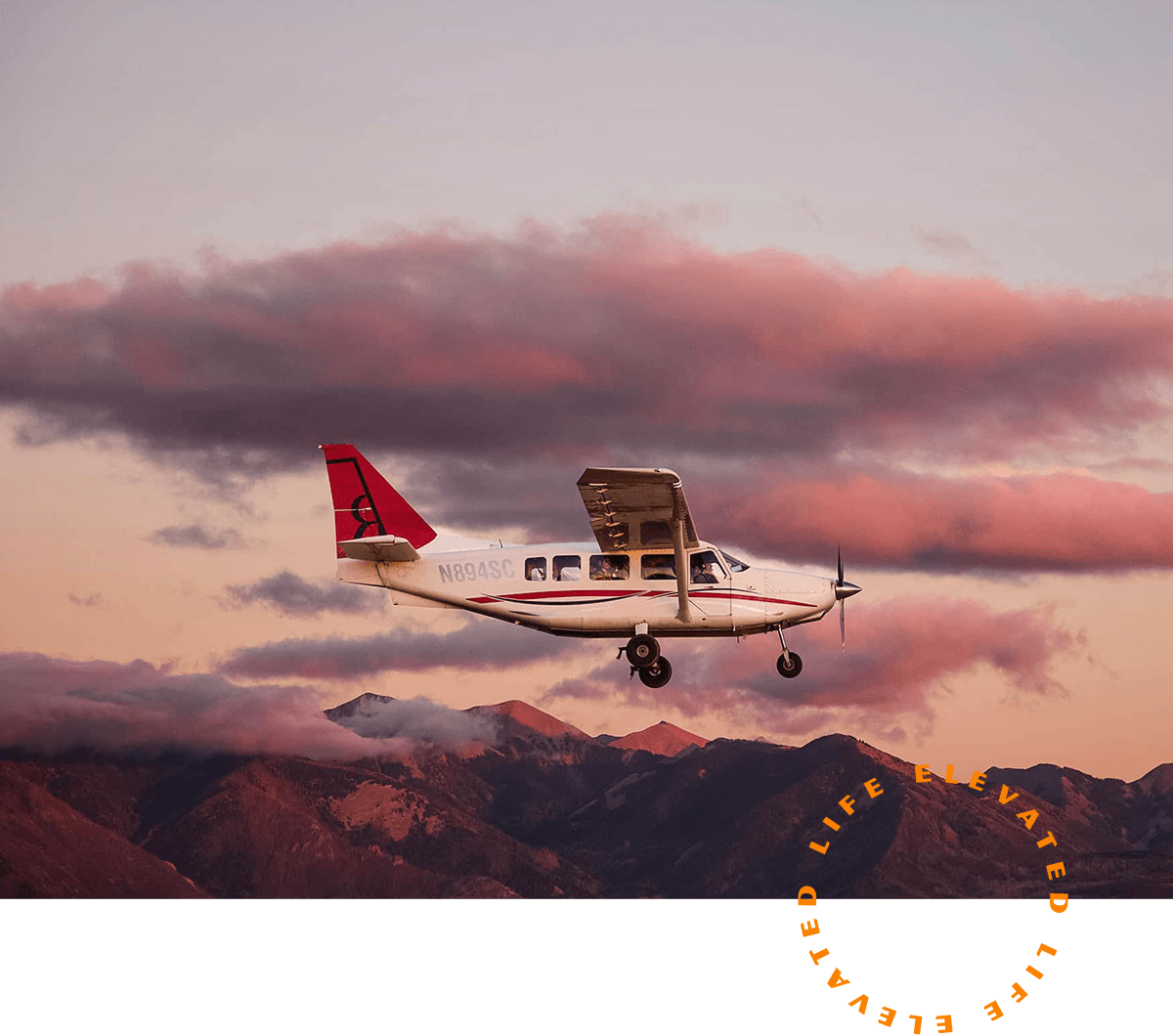 An aircraft flying over a scenic sunset sky
