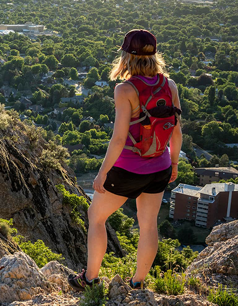 A woman staring from a hilltop