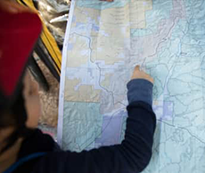 A person pointing out a spot on a map