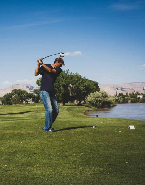 a man playing golf in the desert