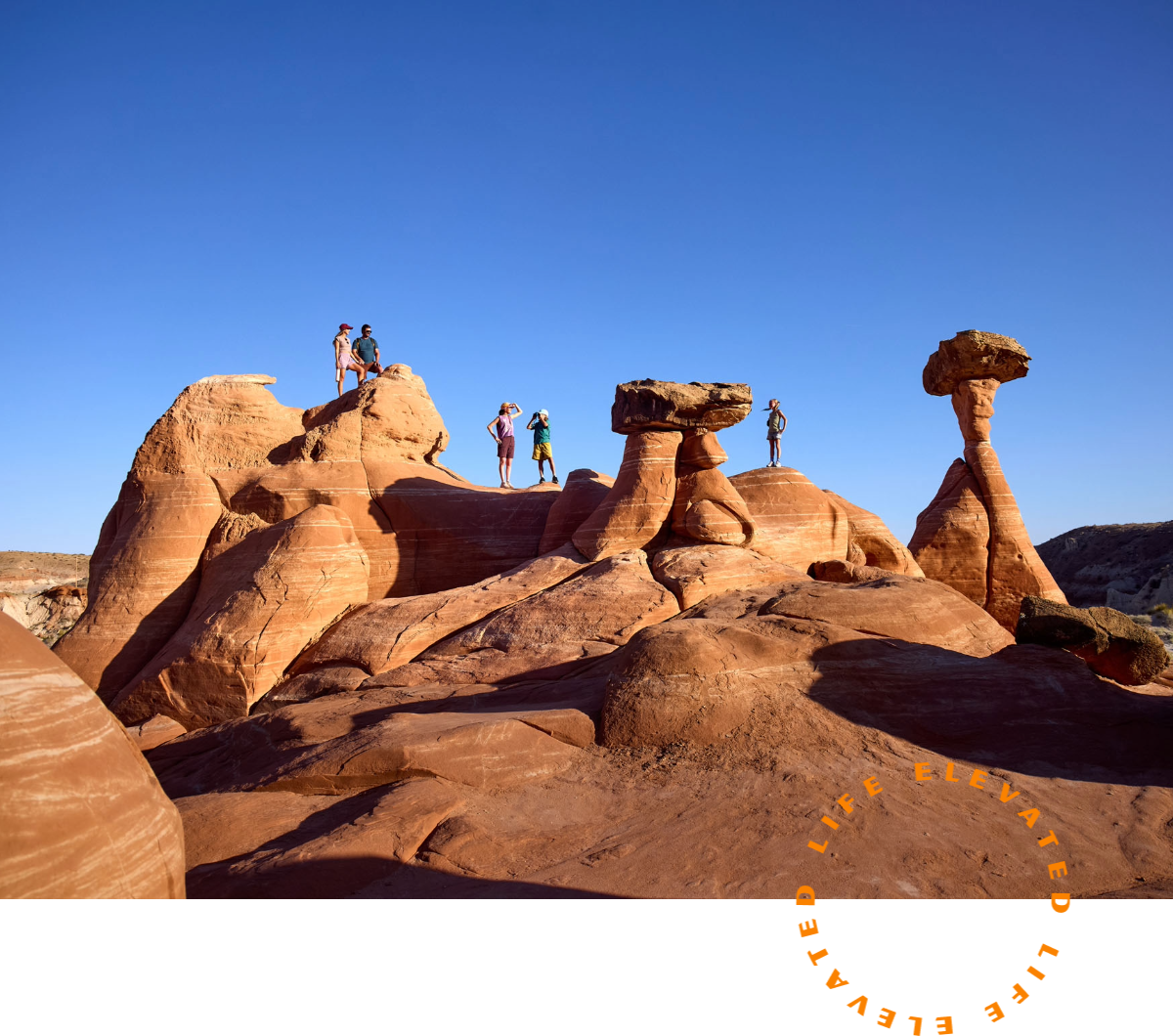 a group of people standing on top of a rock formation