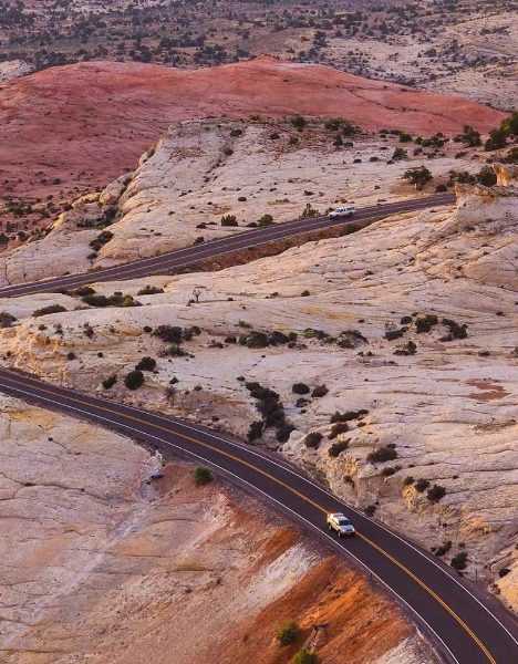 a car driving down a road in the desert