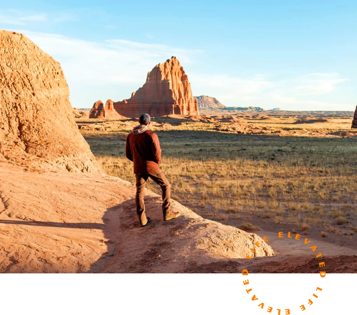 a person standing on a rock in the desert
