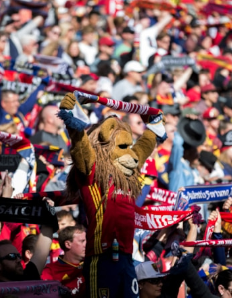 a man in a lion costume stands in front of a crowd