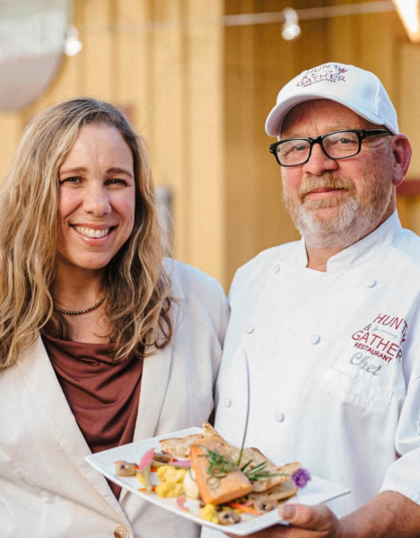 a man and woman holding plates of food