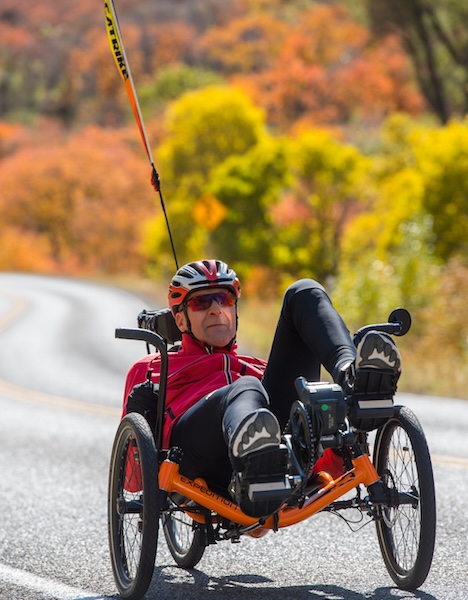 a person in a wheelchair on the side of a road