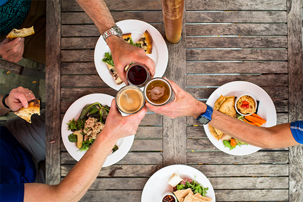 Hands reach over a table with