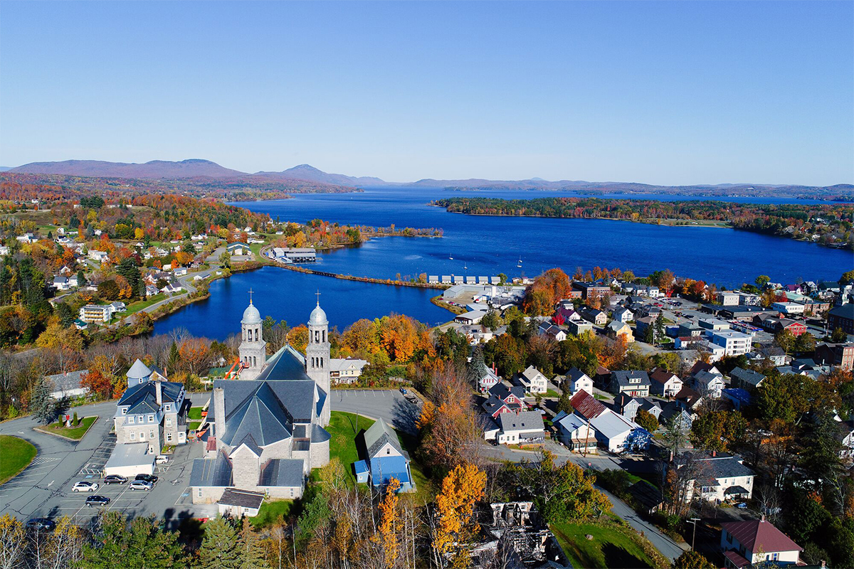 Aerial view of Newport, Vermont surrounded by fall foliage on the shores of Lake Memphremagog.