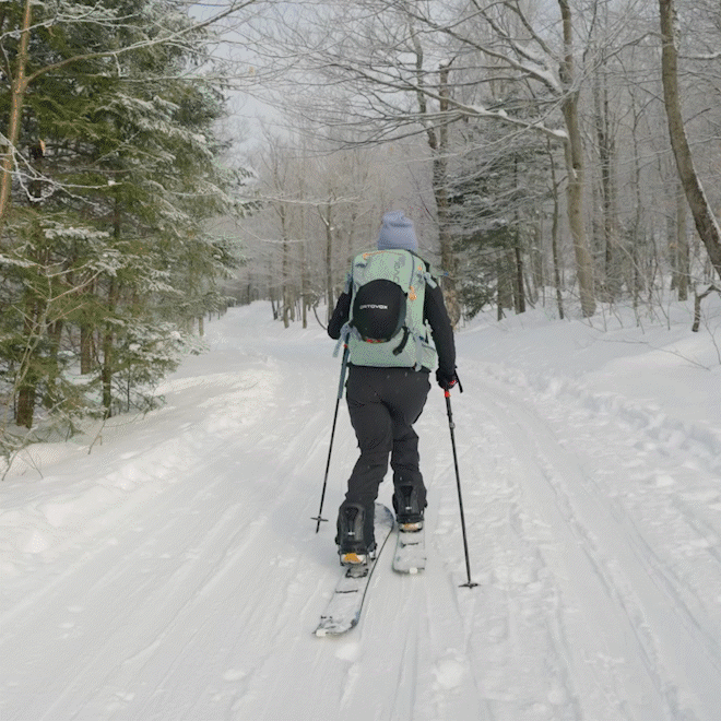 a man is skiing down a snow covered path on skis