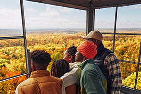 Family admiring the fall foliage from a viewpoint