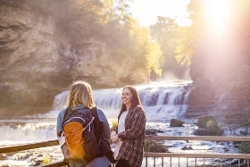 Two friends talking while enjoying a view of the waterfall