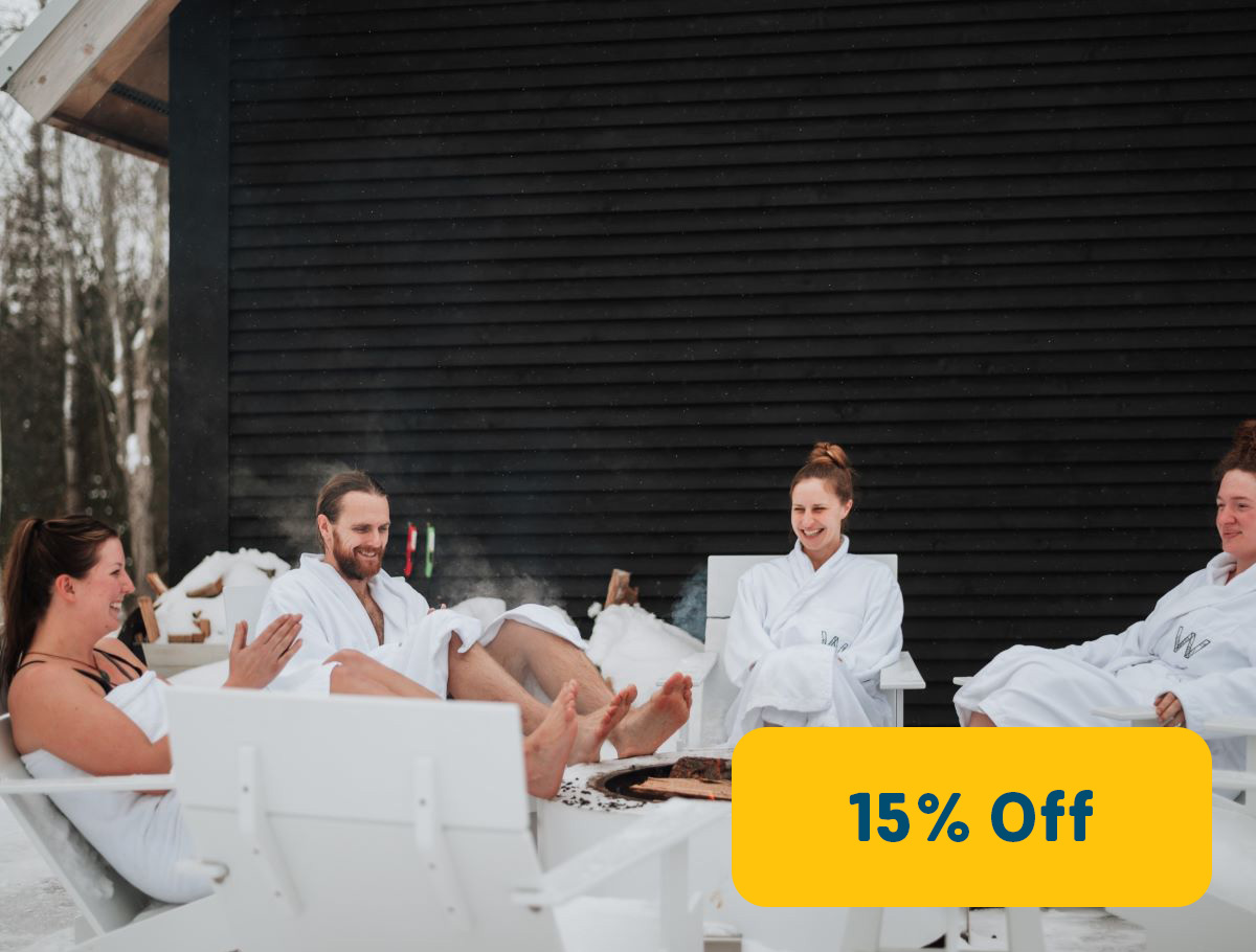 couples at spa retreat sitting around an outdoor fire pit in bath robes