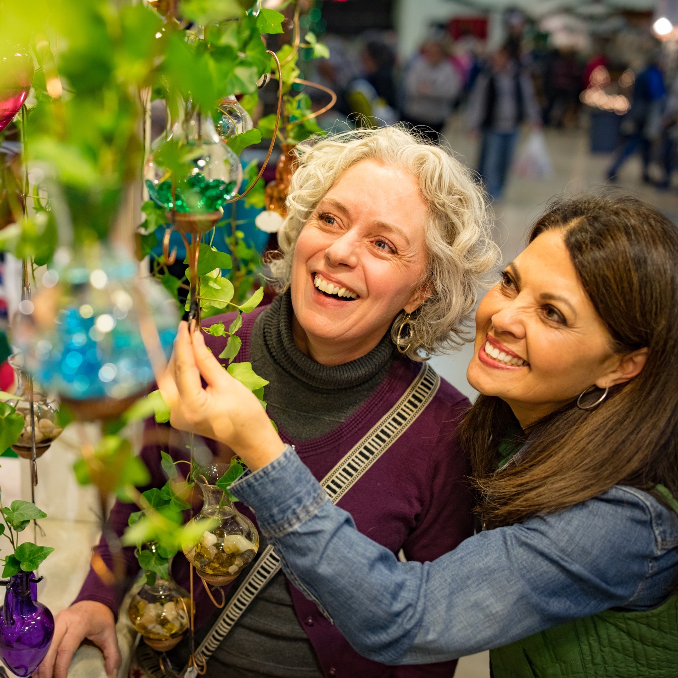 Two women looking at holiday decorations 