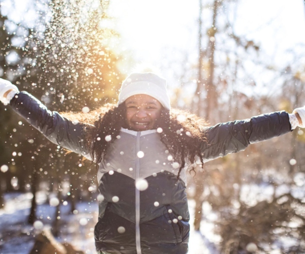 Little girl smiling outside in the snow 