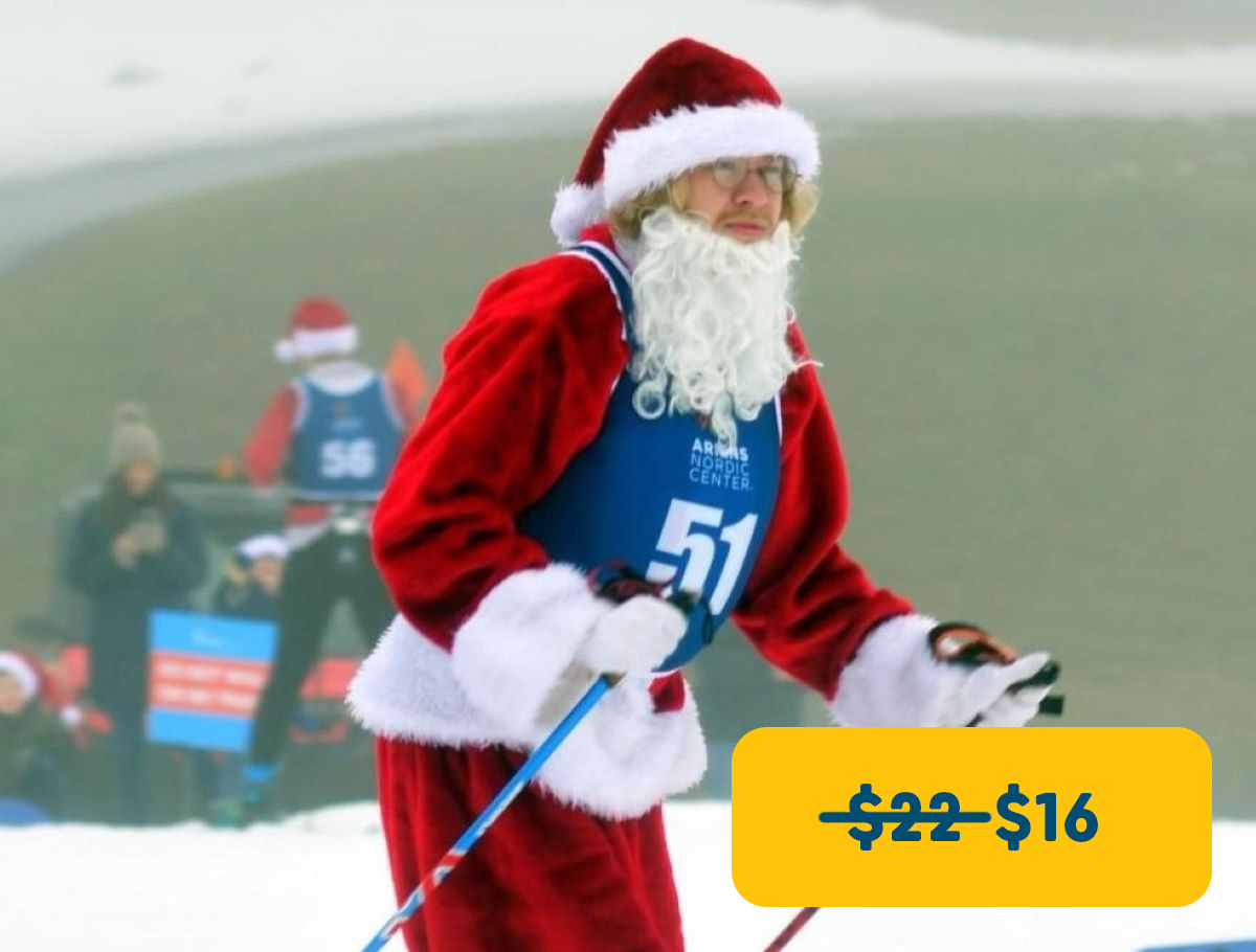 Man dressed as santa cross country skiing 