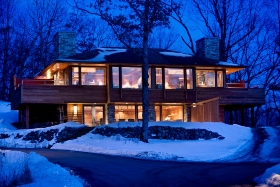 Exterior view of beautiful cabin at night in winter 