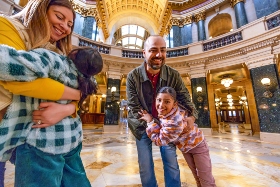 family in atrium of the capital building in madison 