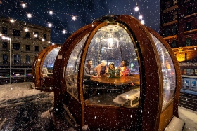 friends dining in an outdoor igloo