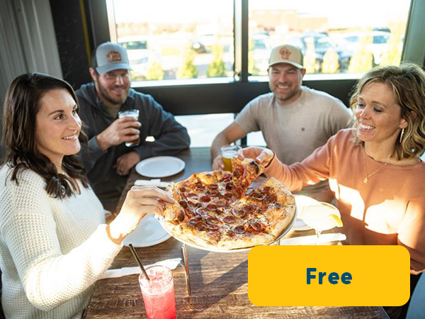 Friends enjoying pizza at local restaurant