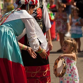 little girl holding tambourine during festa italiana 
