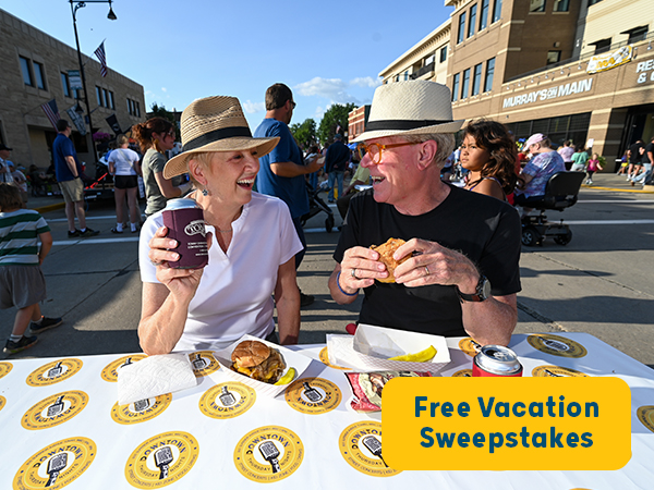 couple enjoying food at outdoor event 