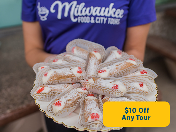 milwaukee food tours guide holding tray of cannoli's 