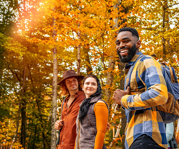 friends walking along a path during fall 