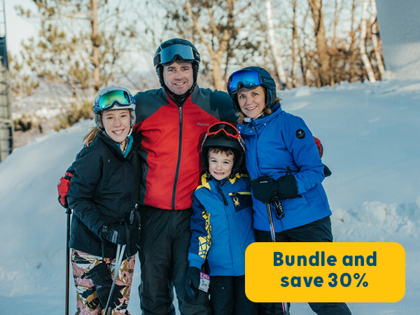 family posing for a photo on a ski hill 