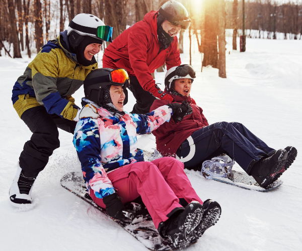 friends playing on snowboards