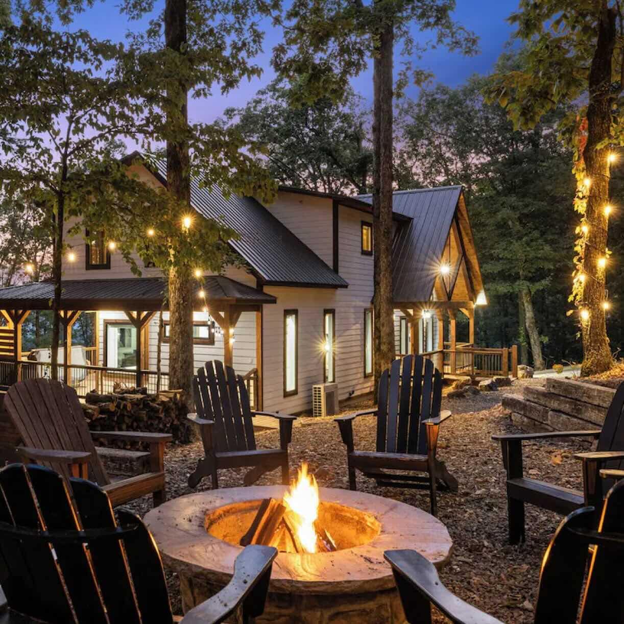 The spacious yard of a vacation home featuring a firepit