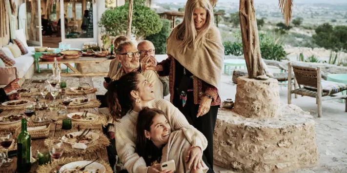 Friends gather to share a meal on the beautiful patio of a vacation home.