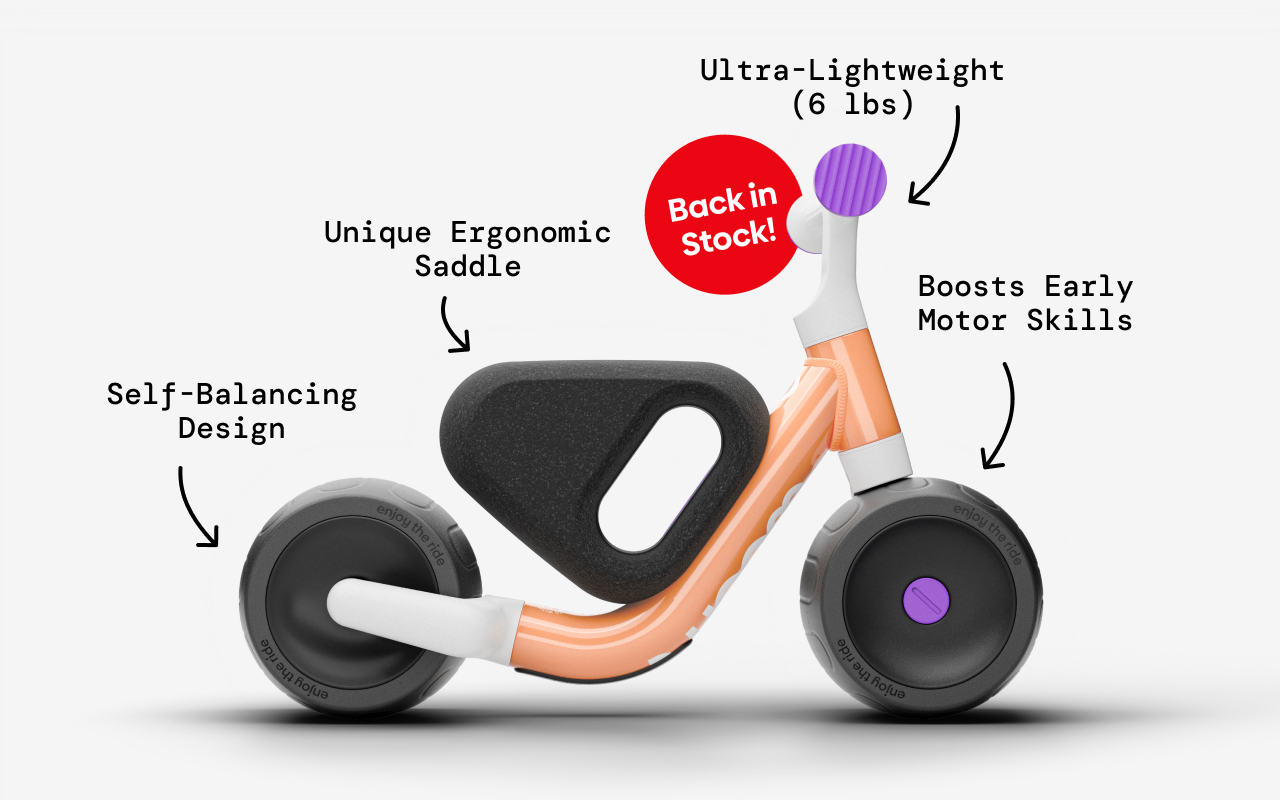 woom WOW in pop peach with arrows pointing to features: self-balancing design, unique ergonomic saddle, ultra-lightweight (6lbs), boosts early motor skills