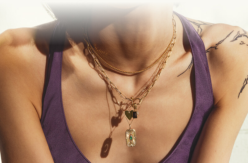 A woman close up, showcasing her beautiful Whimly by Zales  Necklaces.