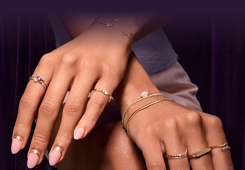 Woman's hands showcasing her beautiful layered Rings and Bracelets.