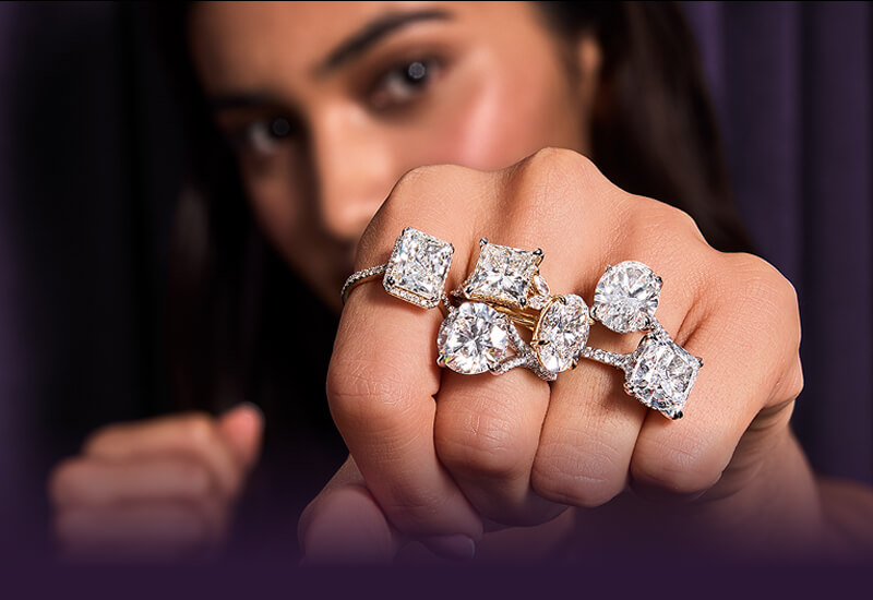 A woman punching pose showcasing her beautiful Rings.