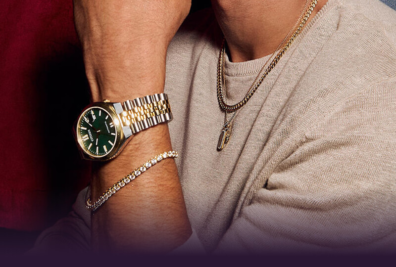 A man showcasing his stunning Necklaces, watch and Bracelet.
