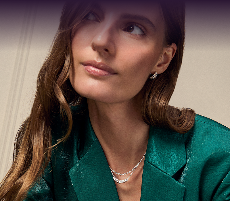 A woman looking away, showcasing her beautiful Earrings and Necklaces.