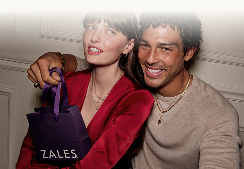 A smiling couple wearing holiday theme Jewelries - Necklaces, Earrings, Rings. 