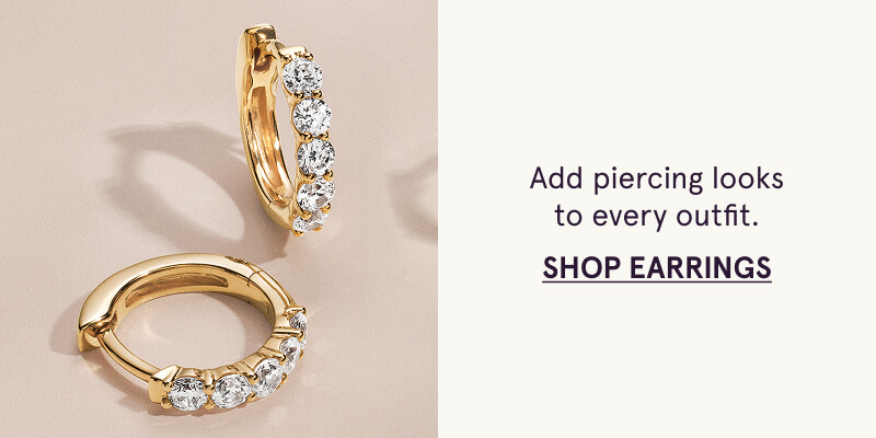A pair of gold huggie earrings with diamond details. Add piercing looks. Click here to shop new earrings