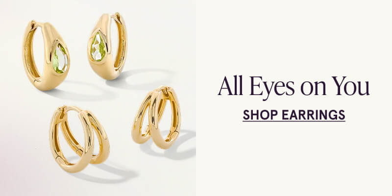 Gold hoop earrings with green gemstone detail, and double layered gold hoops. All eyes on you. Click here to shop earrings
