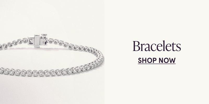 A white metal diamond tennis bracelet. Click here to shop bracelets